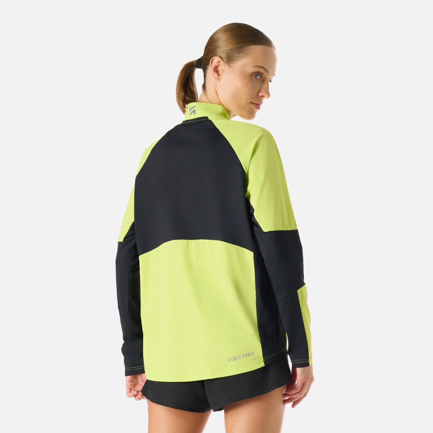 Parte trasera del Polerón Mujer Built To Move Pro 1/4 Zip Midlayer Verde Lima Vulcano con panel negro, diseñado para máxima movilidad y protección.