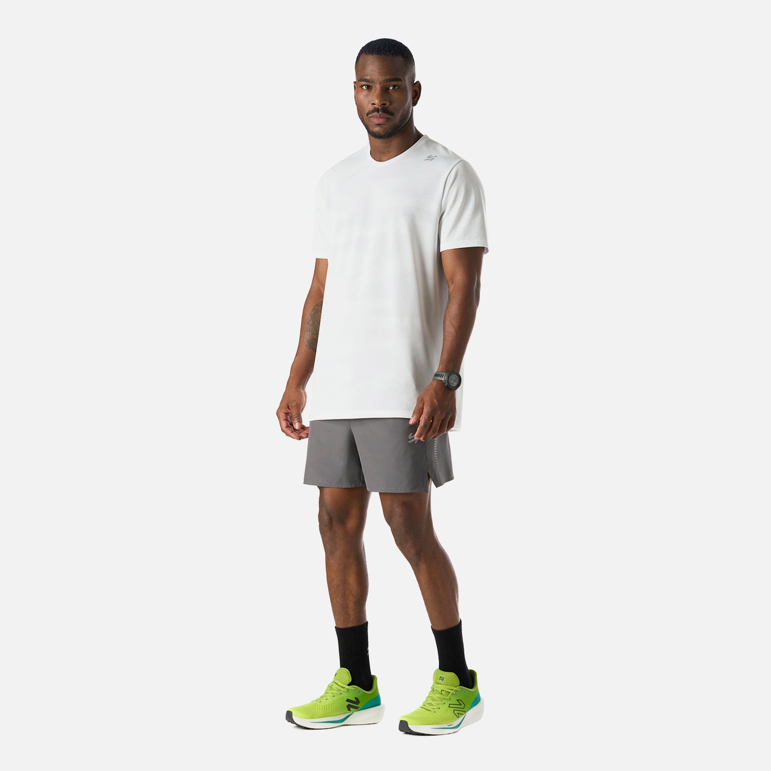 Conjunto deportivo con Polera Hombre Built To Move Pro T-Shirt Blanco Vulcano y short gris, ideal para actividades de running y training.